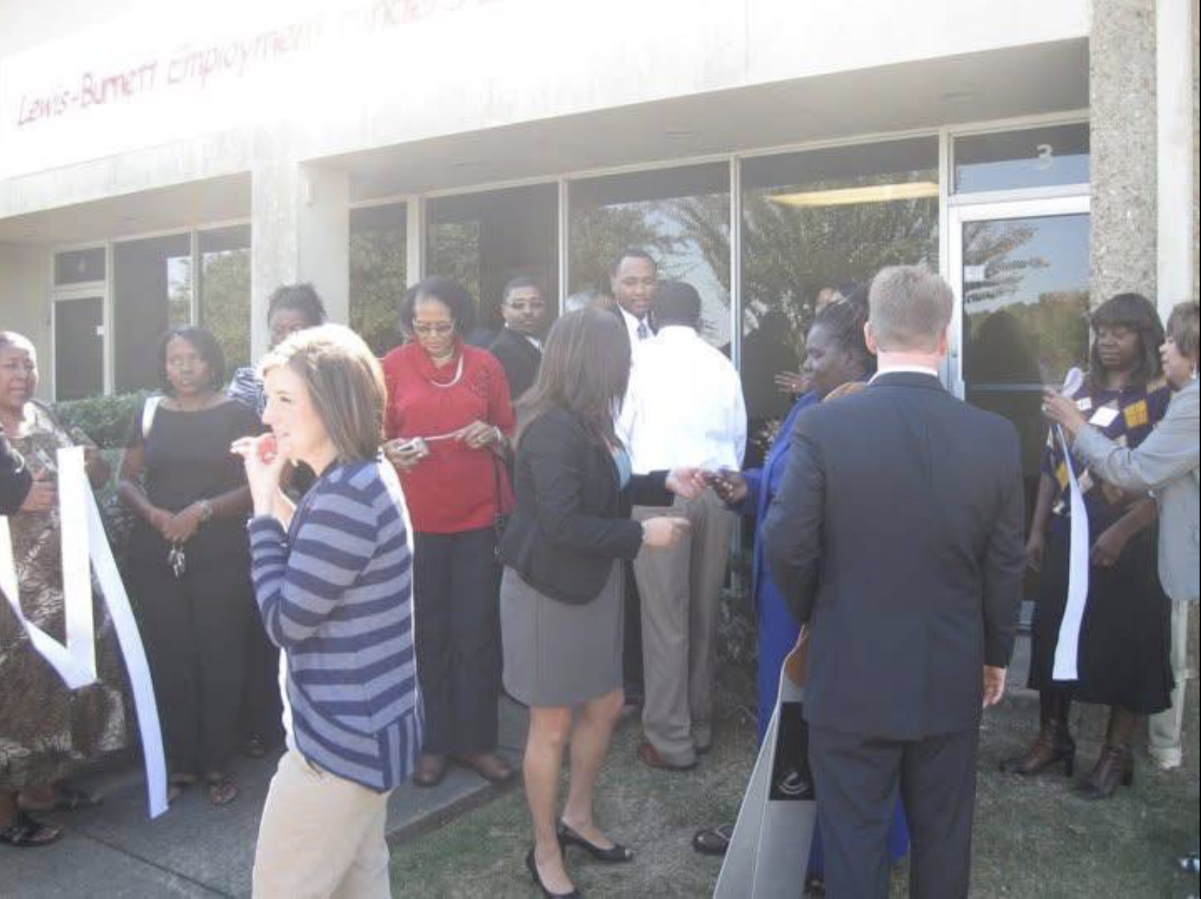 Community members and city officials gathered for the ribbon cutting outside the Lewis-Burnett Employment Finders office in Little Rock